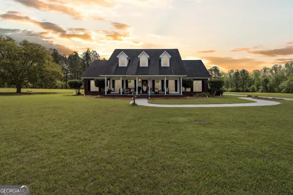 a view of a big room with a big yard and large trees