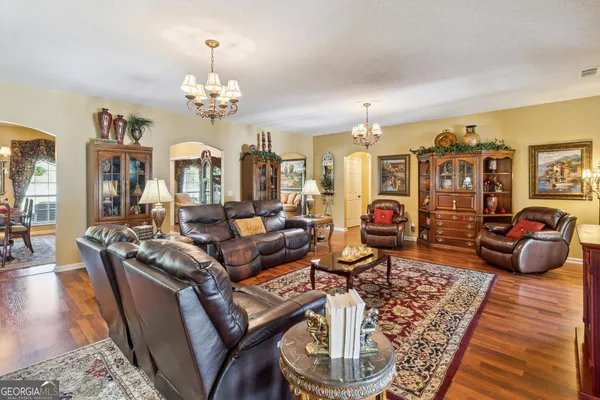 a view of a dining room with furniture and chandelier