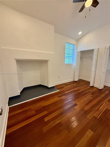 a view of room and hall with wooden floor