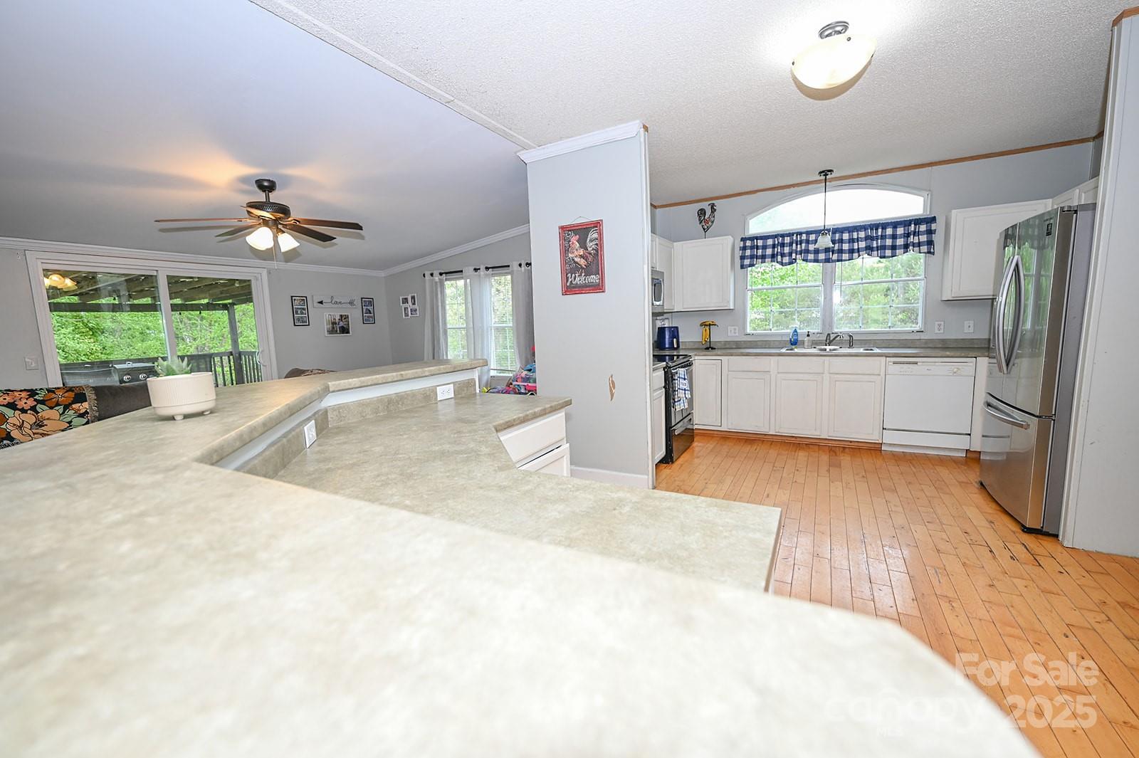 307 Dewitt Owens Road Rutherfordton, NC 28139 - Photo 11 of 40 a large white kitchen with a large window and stainless steel appliances
