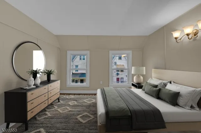 a bedroom with a bed and a mirror on dresser