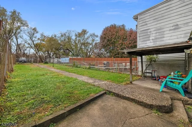 a view of backyard with seating space and trees