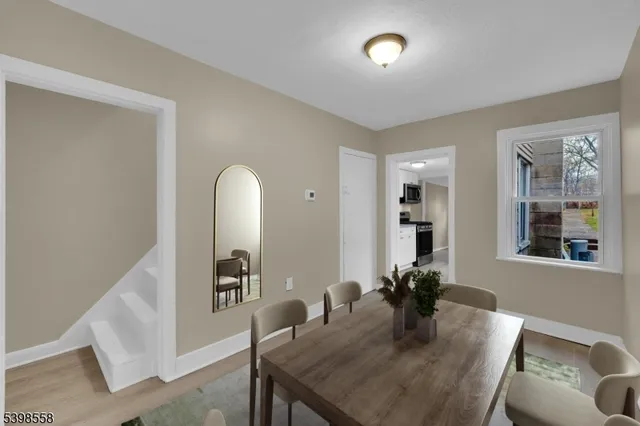 a view of a dining room with furniture and window