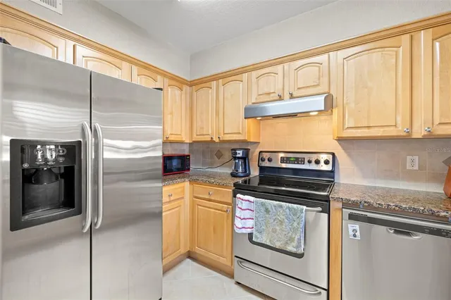 a kitchen with a stove and a refrigerator