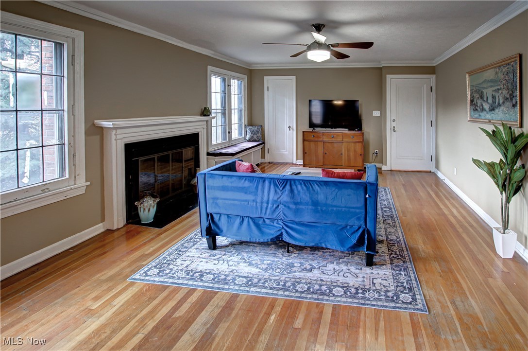 17800 Winslow Road Beachwood, OH 44122 - Photo 22 of 31 Living room with light hardwood / wood-style floors, a healthy amount of sunlight, and crown molding