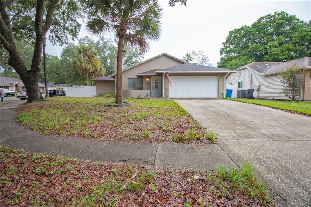 4142 Yellowwood Drive Valrico, FL 33594 - Photo 1 of 1 front view of a house with a yard