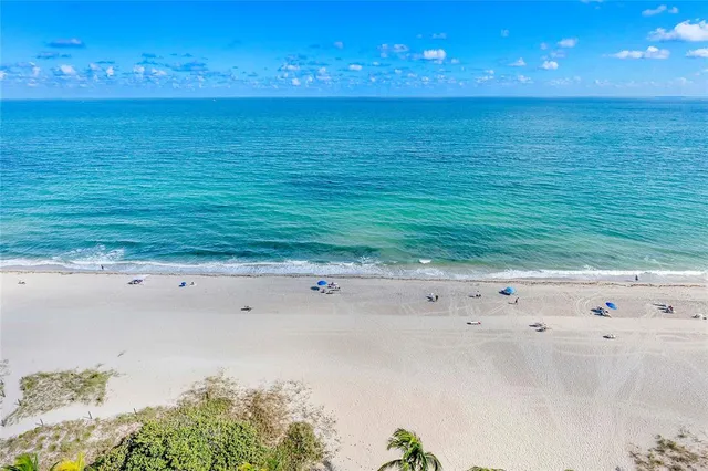 a kitchen with stainless steel appliances granite countertop a stove refrigerator and a sink