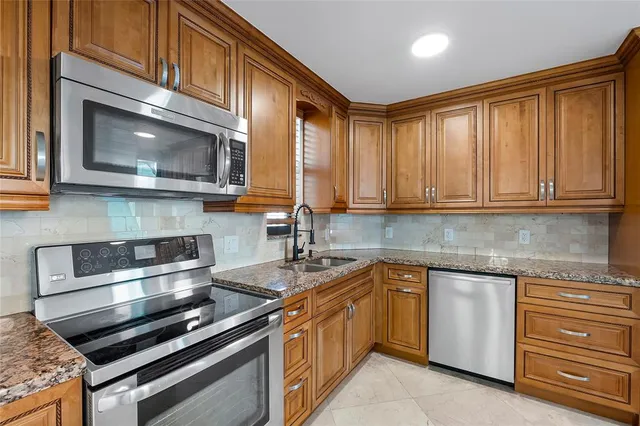 a view of a room with furniture and a chandelier