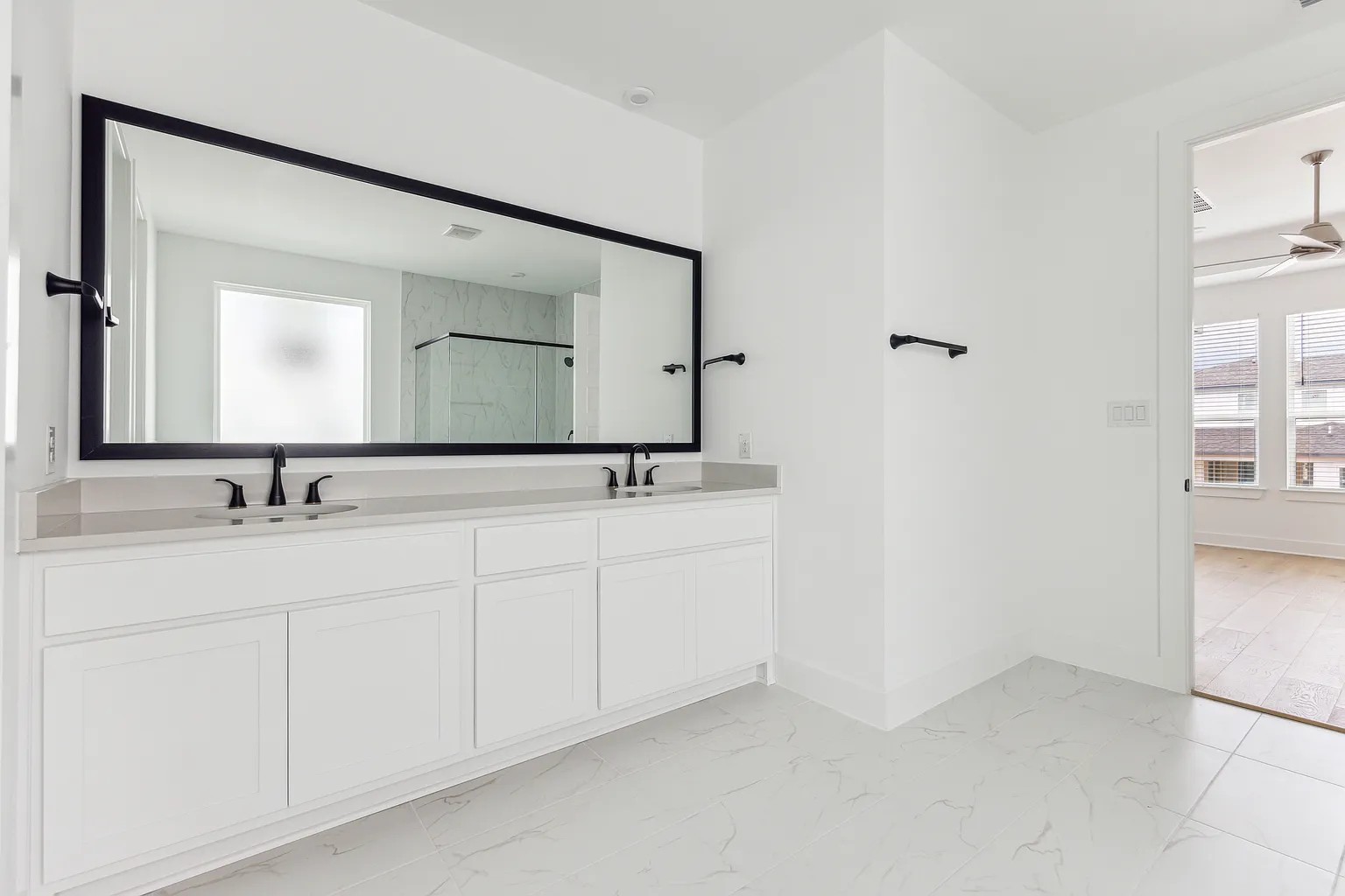 1909 Varese Path Leander, TX 78641 - Photo 20 of 40 A spacious primary bathroom boasts a double vanity with ample counter space, ideal for daily routines.