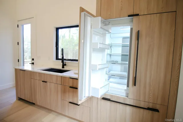 a bathroom with a double vanity sink a mirror and a shower