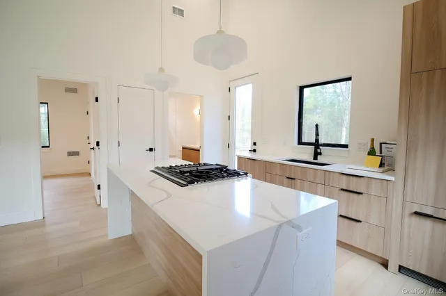 a kitchen with stainless steel appliances a stove a sink and a refrigerator