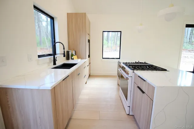 a kitchen that has a sink and a stove