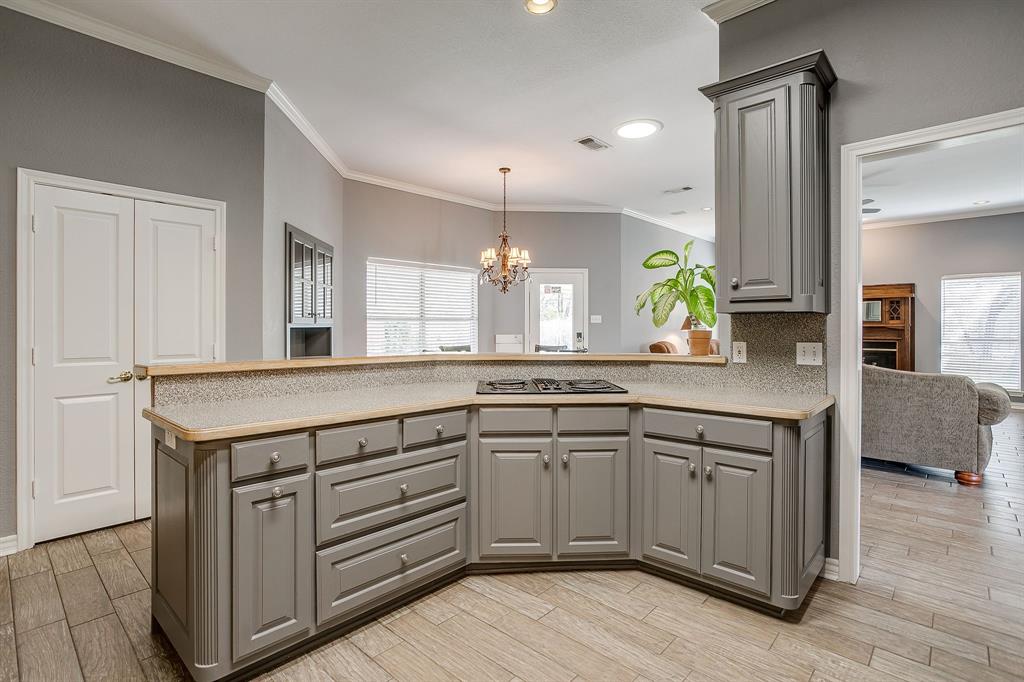 2300 Walter Smith Road Azle, TX 76020 - Photo 12 of 40 a kitchen with a sink cabinets and wooden floor