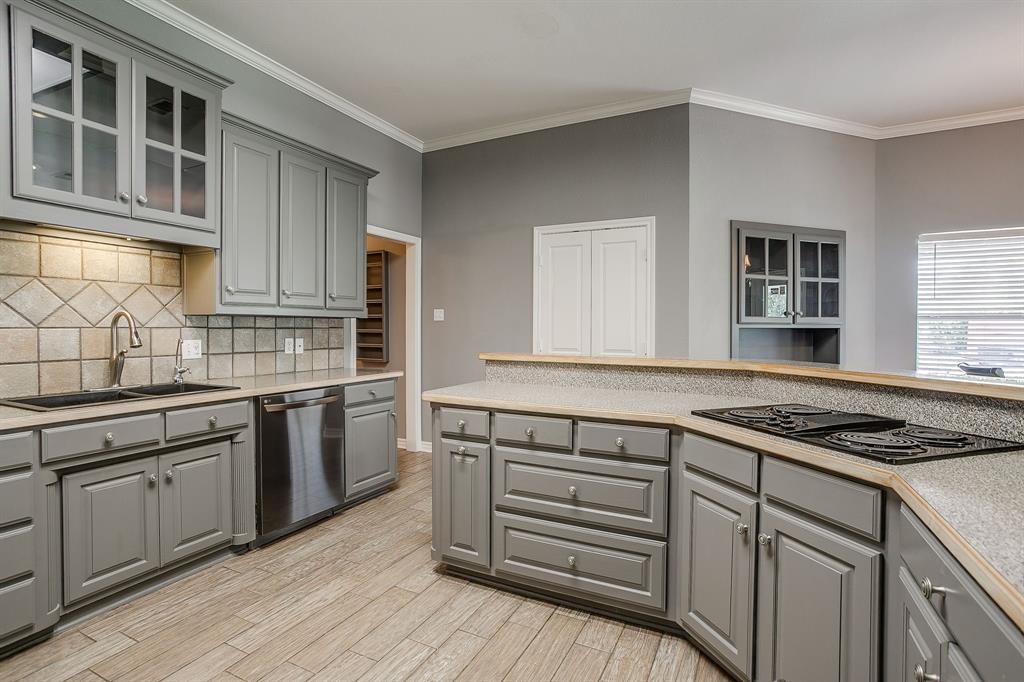 2300 Walter Smith Road Azle, TX 76020 - Photo 13 of 40 a kitchen with granite countertop a stove cabinets and wooden floor