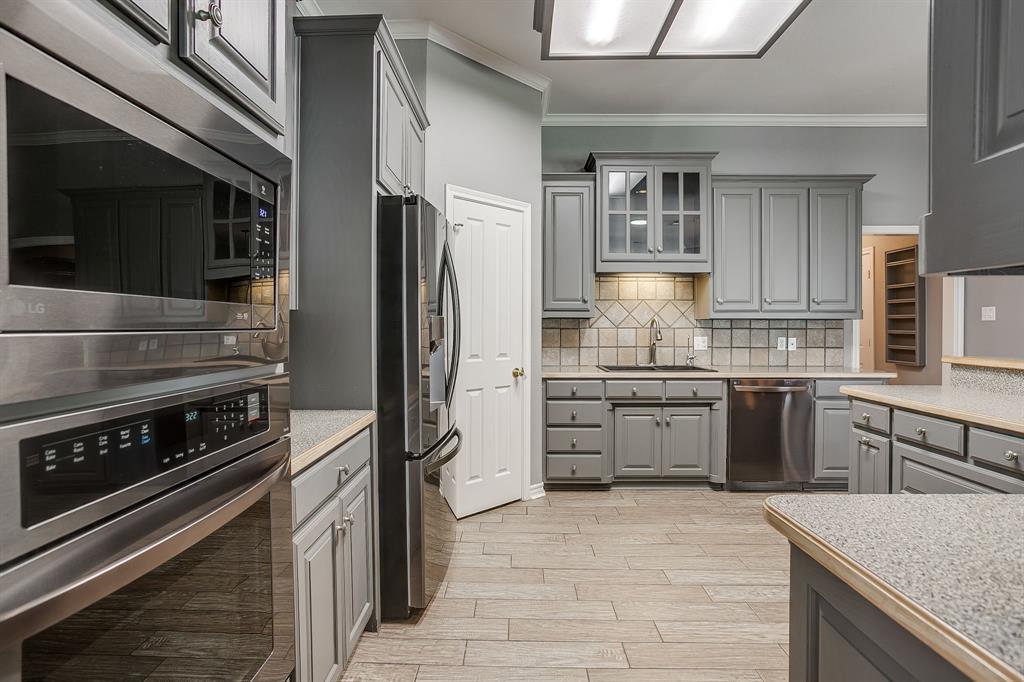 2300 Walter Smith Road Azle, TX 76020 - Photo 14 of 40 a kitchen with stainless steel appliances granite countertop a refrigerator and a stove top oven