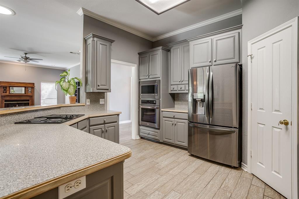 2300 Walter Smith Road Azle, TX 76020 - Photo 15 of 40 a kitchen with a refrigerator stove and sink