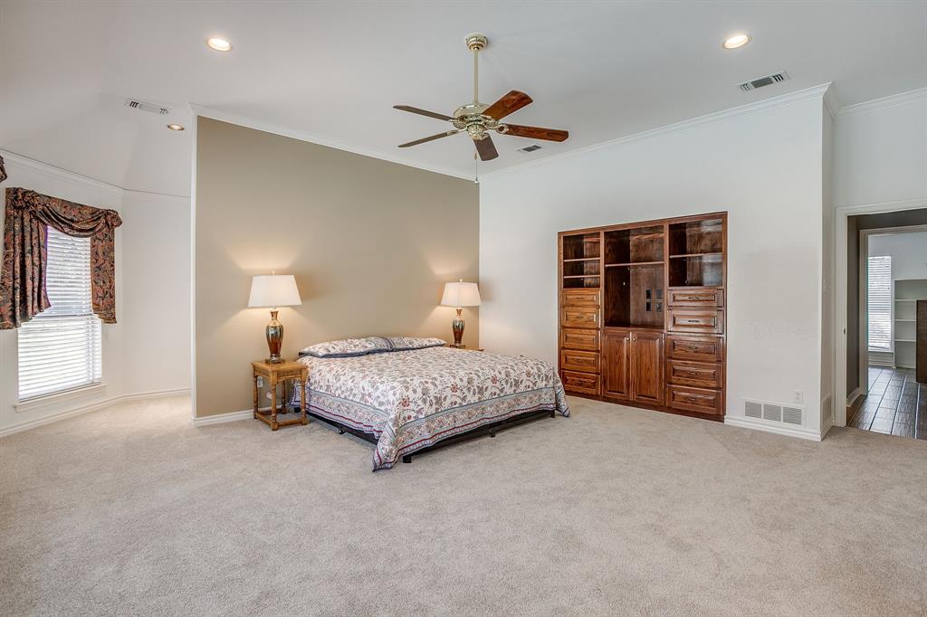2300 Walter Smith Road Azle, TX 76020 - Photo 23 of 40 a bedroom with a bed and a chandelier