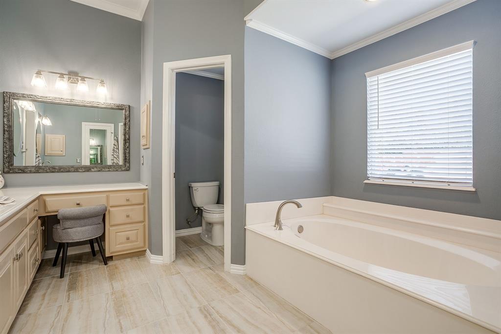 2300 Walter Smith Road Azle, TX 76020 - Photo 26 of 40 a bathroom with a bathtub sink and a window