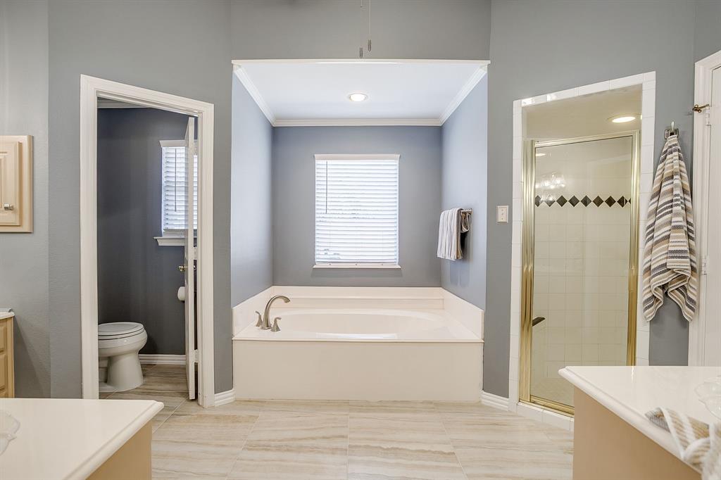 2300 Walter Smith Road Azle, TX 76020 - Photo 27 of 40 a bathroom with a bathtub and a toilet
