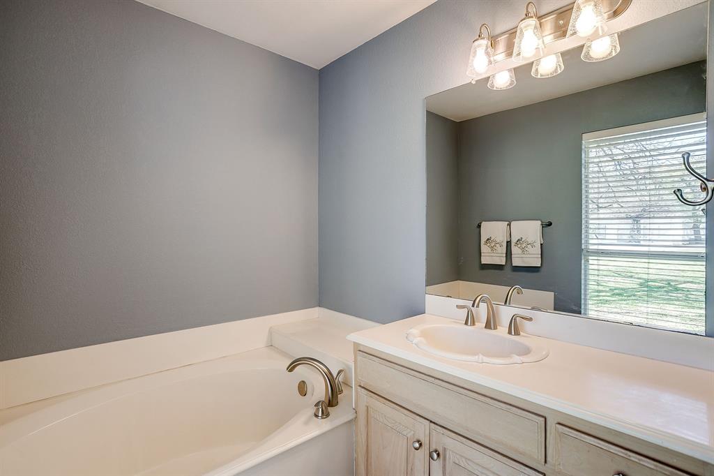 2300 Walter Smith Road Azle, TX 76020 - Photo 28 of 40 a bathroom with a sink and a bathtub