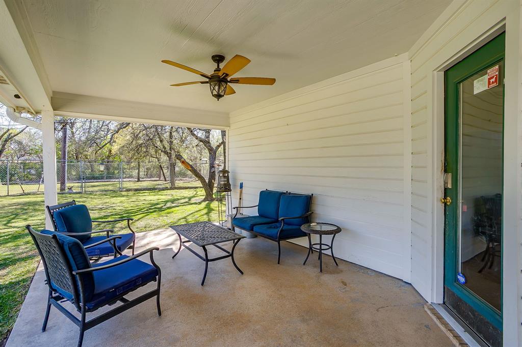 2300 Walter Smith Road Azle, TX 76020 - Photo 32 of 40 a view of a chairs and table in patio with a yard