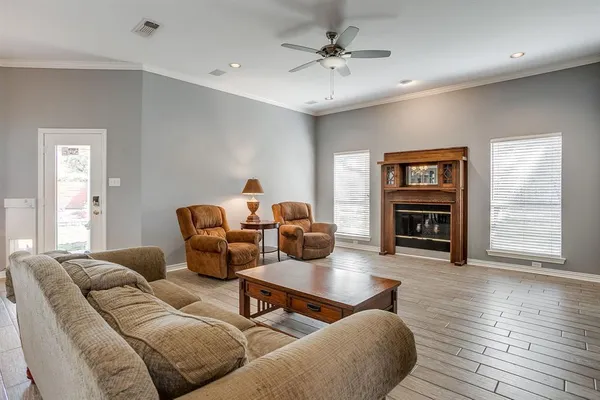 a living room with furniture and a wooden floor