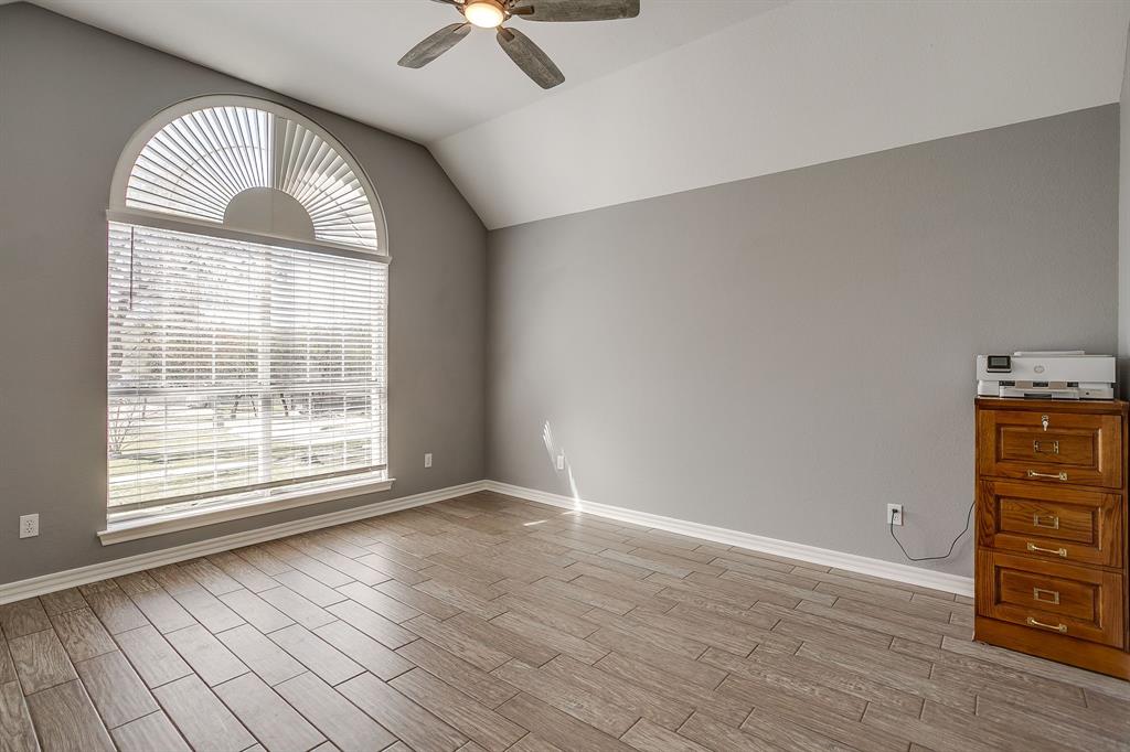 2300 Walter Smith Road Azle, TX 76020 - Photo 10 of 40 an empty room with wooden floor fan and windows