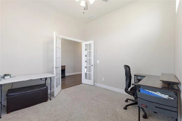 a view of a workspace with furniture and a chair