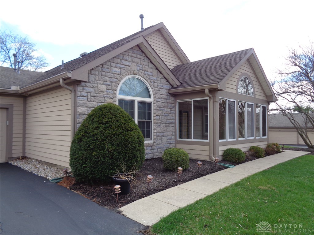 80 Villa Pointe Drive Springboro, OH 45066 - Photo 2 of 19 This residence showcases a blend of natural stone and siding, complemented by an inviting sunroom.