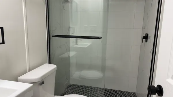 a bathroom with a shower and a toilet