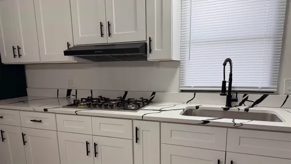 a sink with white cabinets
