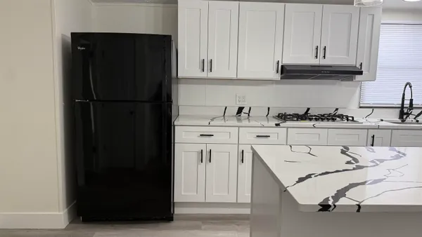a kitchen with stainless steel appliances a refrigerator and cabinets