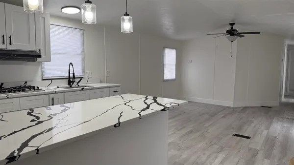 a kitchen with a sink cabinets and window