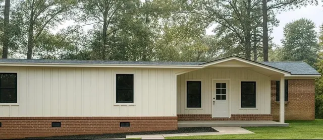 a front view of a house with a garden