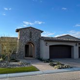 a front view of a house with a garden