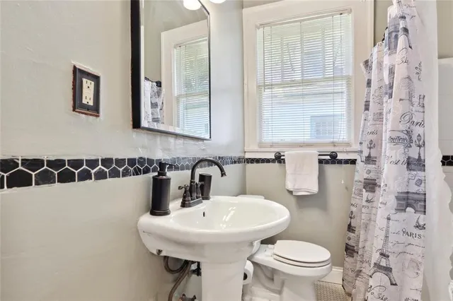 a bedroom with a large bed and a potted plant