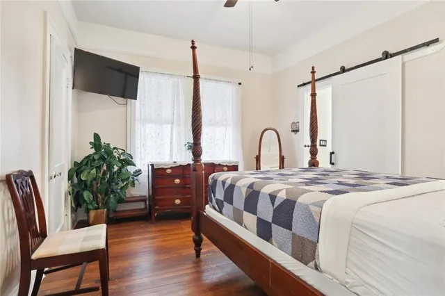 a bedroom with a bed mirror and window