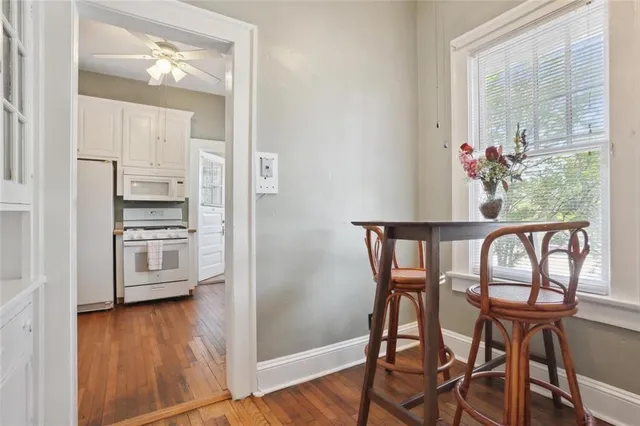 a kitchen with granite countertop white cabinets and white appliances
