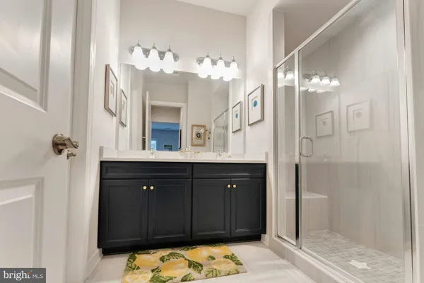 a bathroom with a sink vanity and a mirror