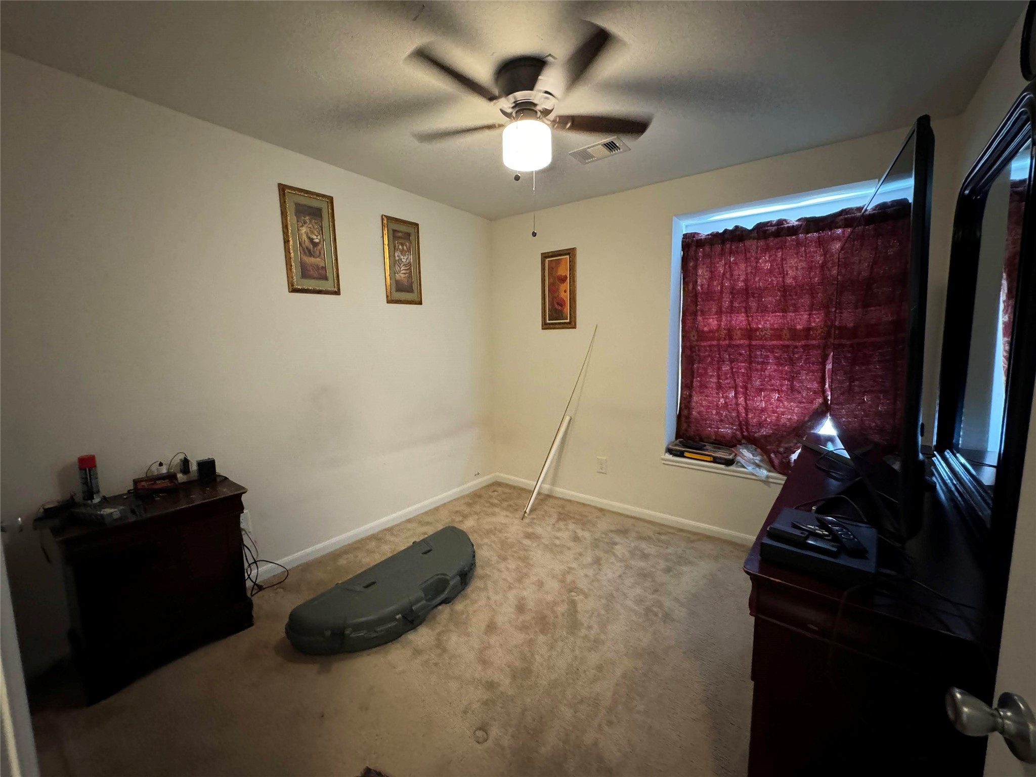 19414 Rookwood Court Houston, TX 77073 - Photo 12 of 19 a room with bed furniture and a flat screen tv