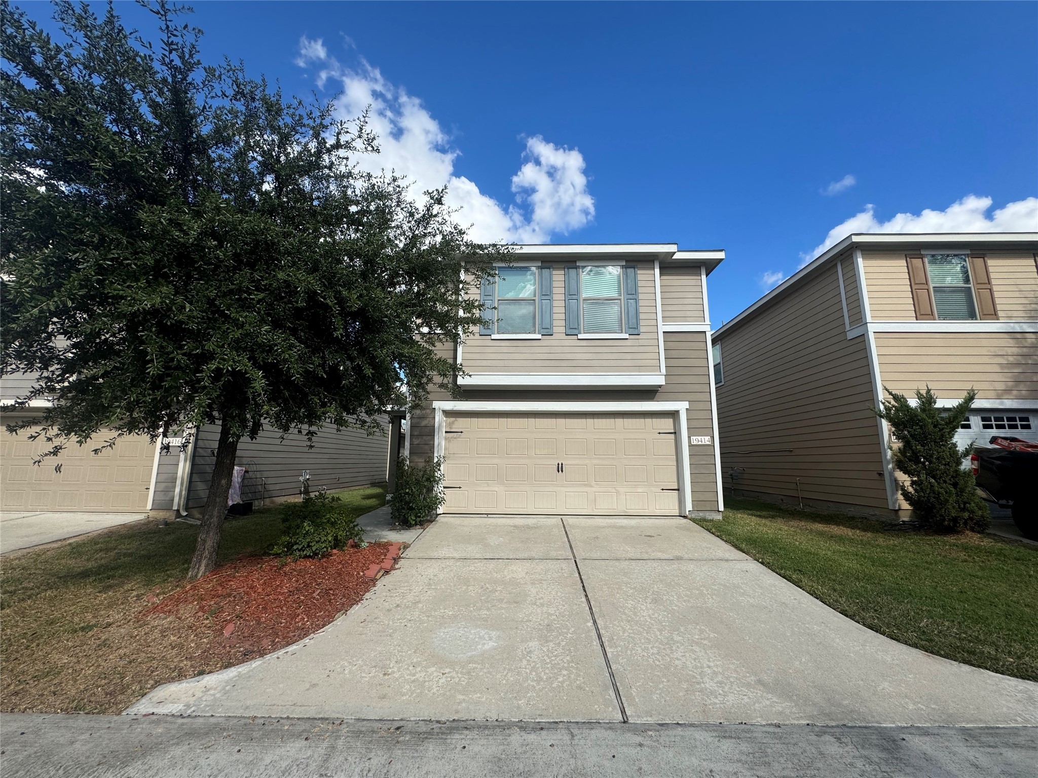 19414 Rookwood Court Houston, TX 77073 - Photo 2 of 19 a front view of a house with a yard and a garage