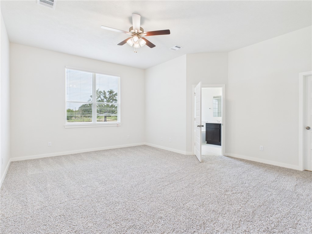 1932 Viva Road Bryan, TX 77807 - Photo 15 of 20 an empty room with windows and ceiling fan