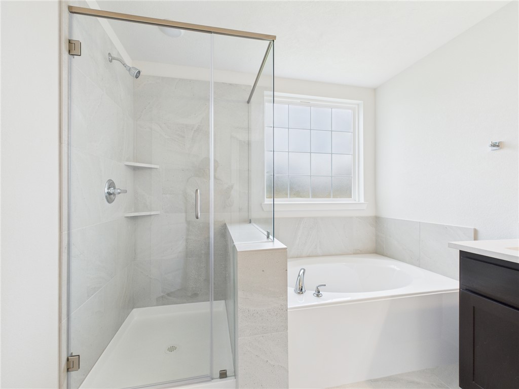 1932 Viva Road Bryan, TX 77807 - Photo 18 of 20 a bathroom with a bathtub and a shower