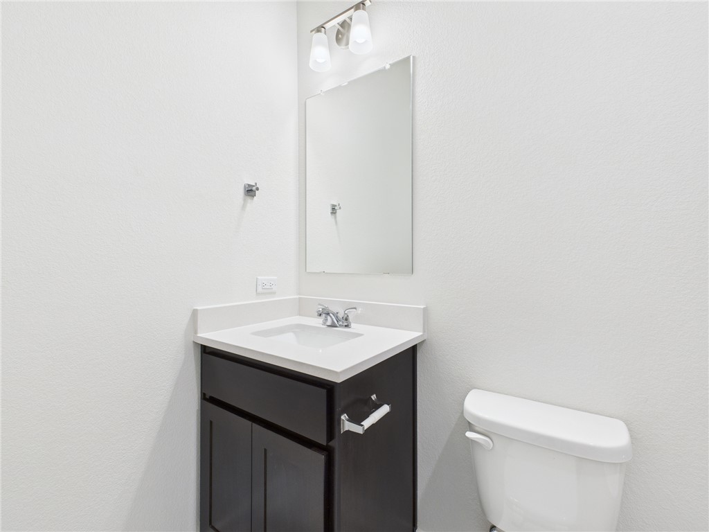 1932 Viva Road Bryan, TX 77807 - Photo 6 of 20 a bathroom with a sink a toilet and mirror