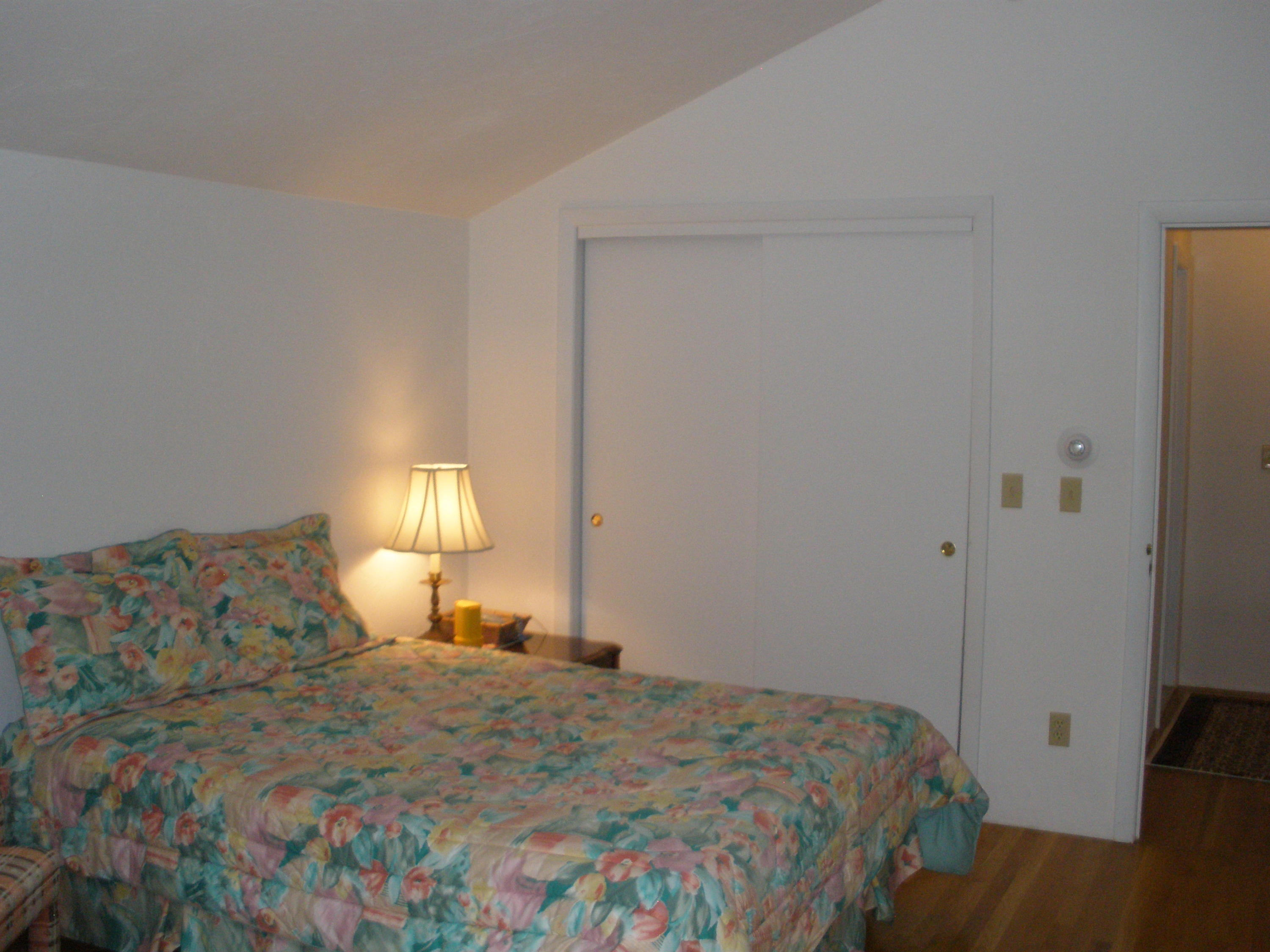 4 Topping Lift Mashpee, MA 02649 - Photo 16 of 24 a bedroom with a bed and a lamp