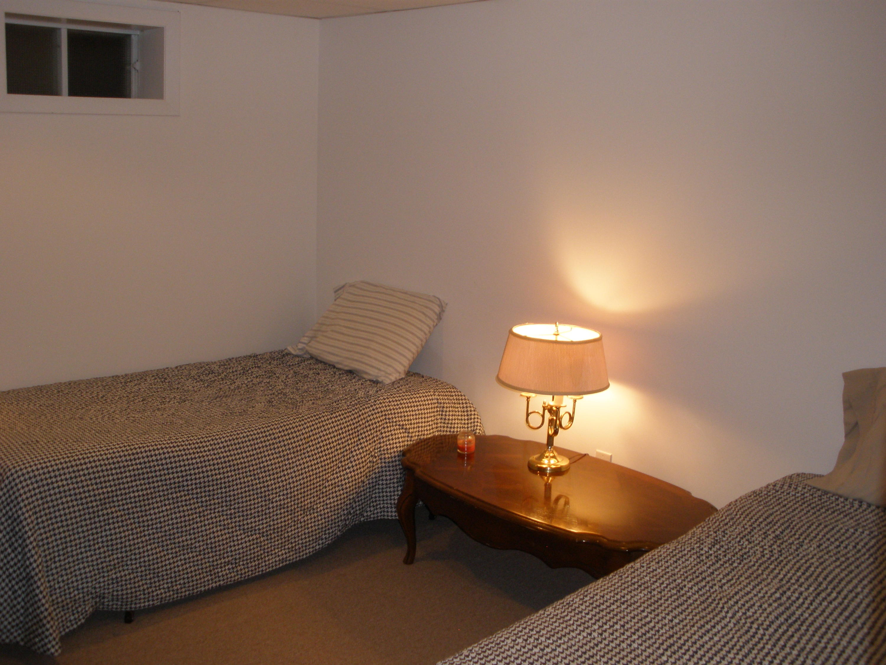 4 Topping Lift Mashpee, MA 02649 - Photo 18 of 24 a bedroom with a bed and a lamp