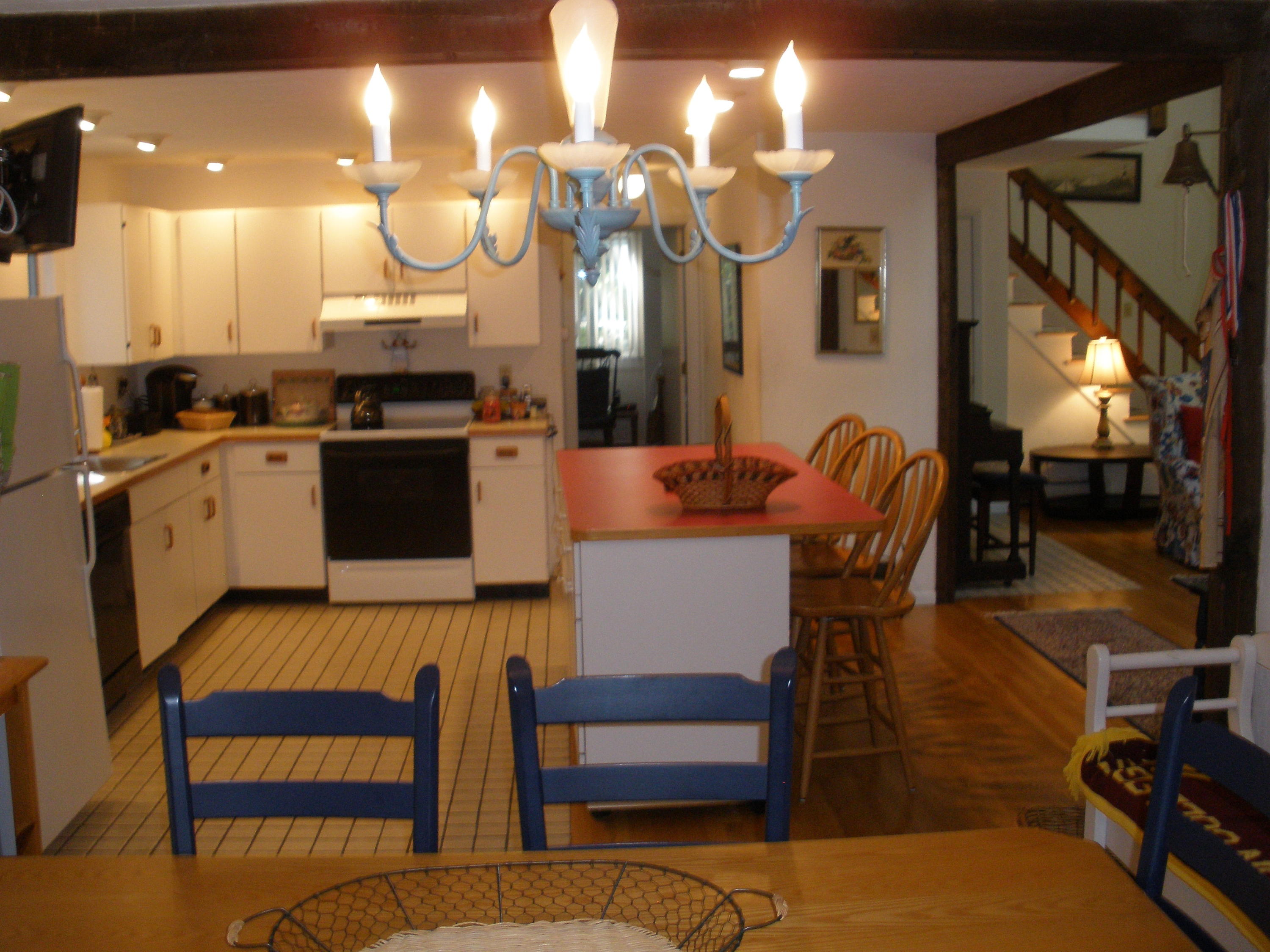 4 Topping Lift Mashpee, MA 02649 - Photo 7 of 24 a open kitchen with stainless steel appliances granite countertop a stove a sink a dining table and chairs with wooden floor