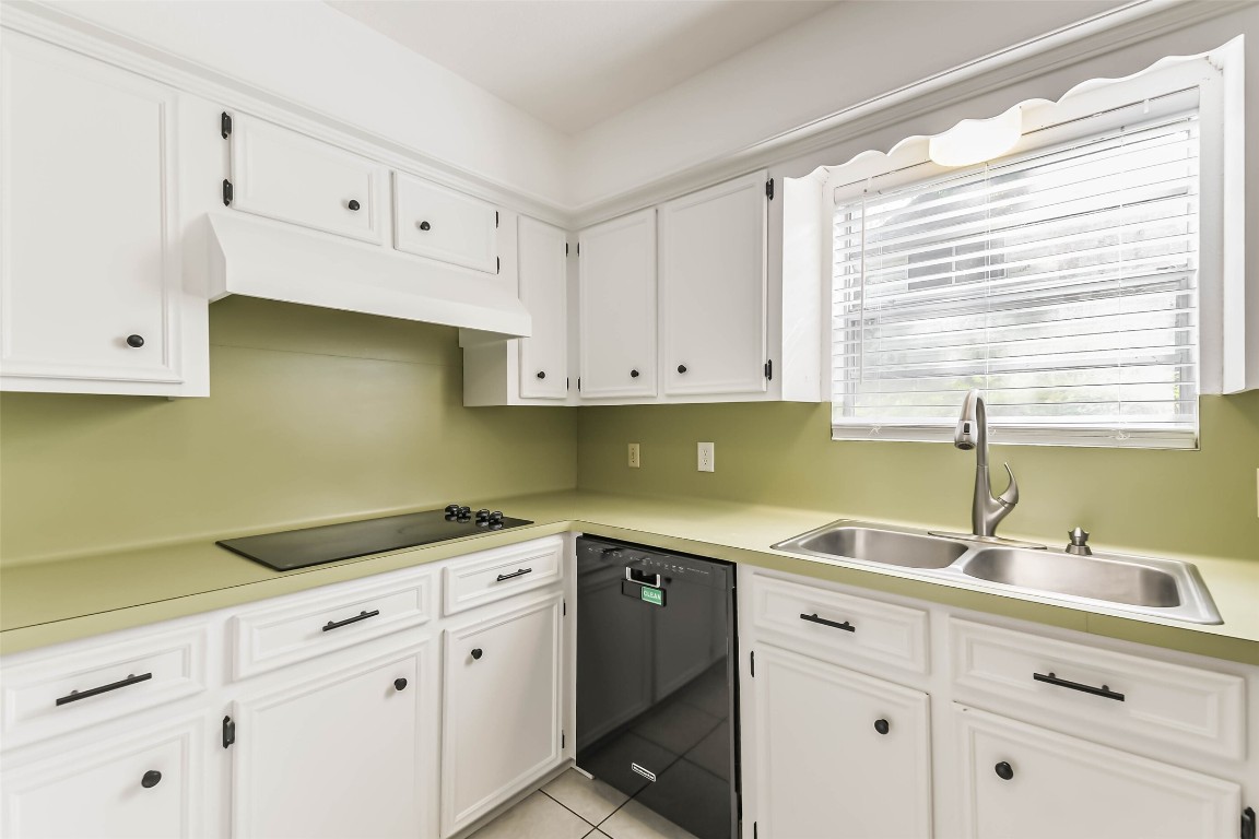 6915 Chancellor Drive Spring, TX 77379 - Photo 13 of 37 a kitchen with white cabinets and a sink