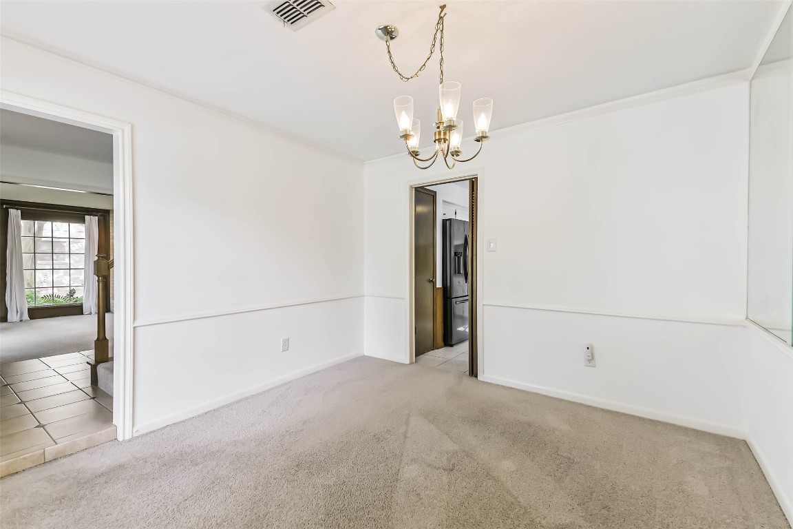 6915 Chancellor Drive Spring, TX 77379 - Photo 17 of 37 a view of a livingroom with a chandelier