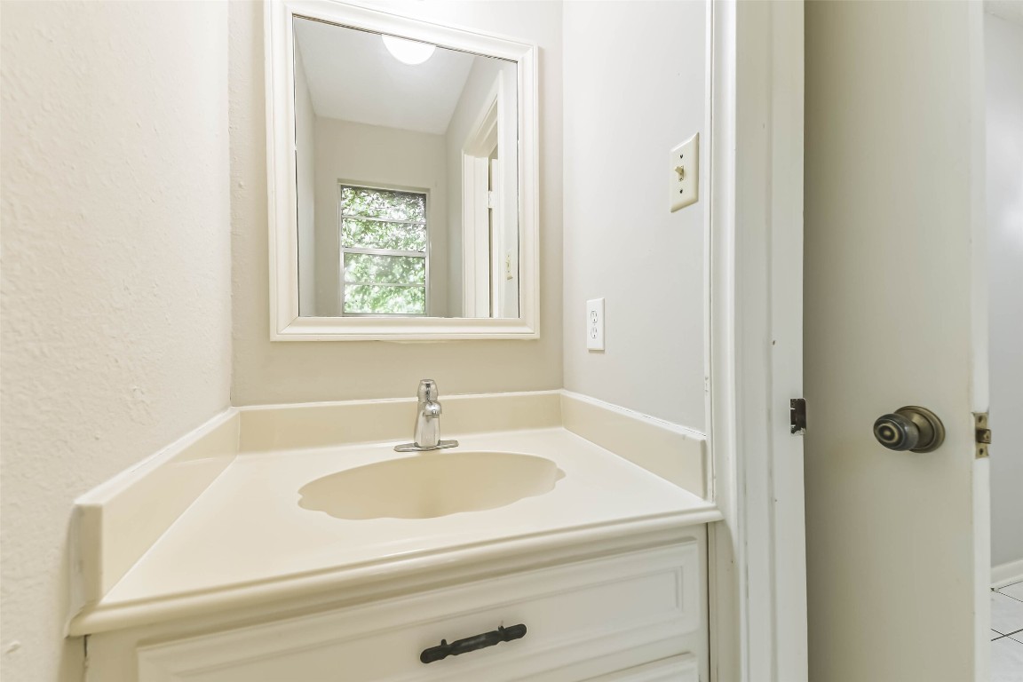 6915 Chancellor Drive Spring, TX 77379 - Photo 20 of 37 a bathroom with a sink and a mirror